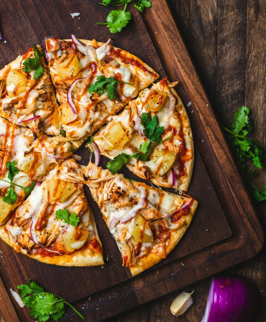 Indulge in a delicious BBQ chicken pizza in Italy, topped with tangy barbecue sauce, juicy pineapple, and fresh cilantro. This mouthwatering pizza combines sweet and savory flavors, with tender shredded chicken and a hint of spice from red onions. Perfect for a family dinner or a casual get-together in Italy, this BBQ chicken pizza is sure to satisfy your cravings.