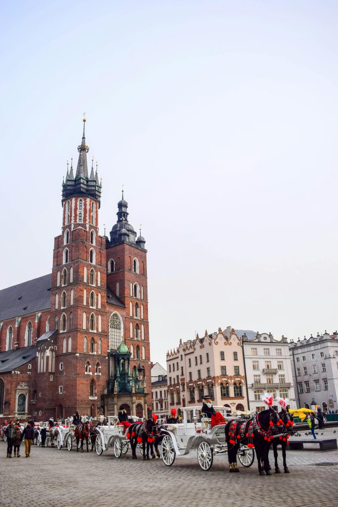 Explore the charm of Kraków, Poland, with its historic architecture and picturesque horse-drawn carriages in the main square. Visit the stunning St. Mary's Basilica, a prime example of Gothic architecture, and experience the rich cultural heritage of this beautiful city. Perfect for history enthusiasts and travelers looking for a unique European destination.

